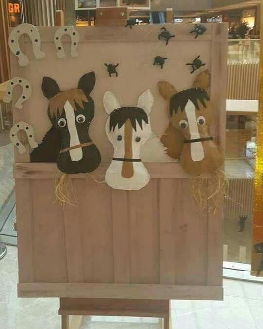 three horse heads on display in a store