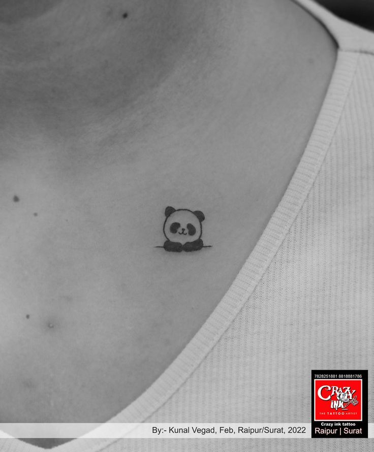 a small panda bear tattoo on the chest