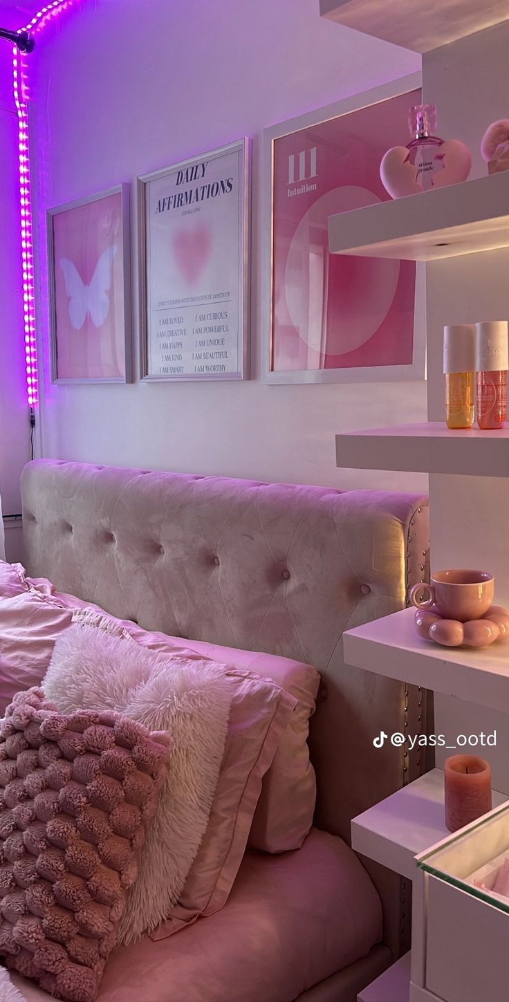 a bed with pink and white pillows in a room that has purple lighting on the walls