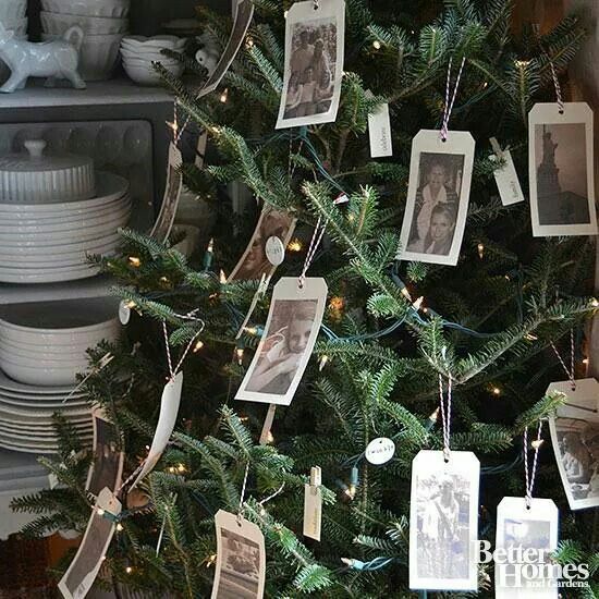 a christmas tree with pictures hanging from it's sides and tags on the branches