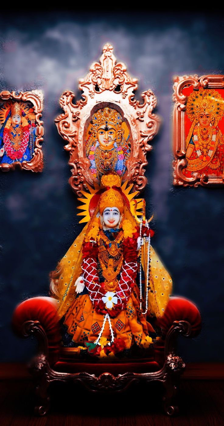 an idol sitting on a red chair in front of paintings