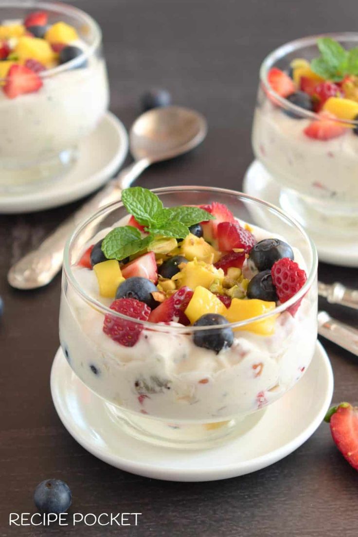 fruit salad in small glass bowls with mint garnish on the top and bottom