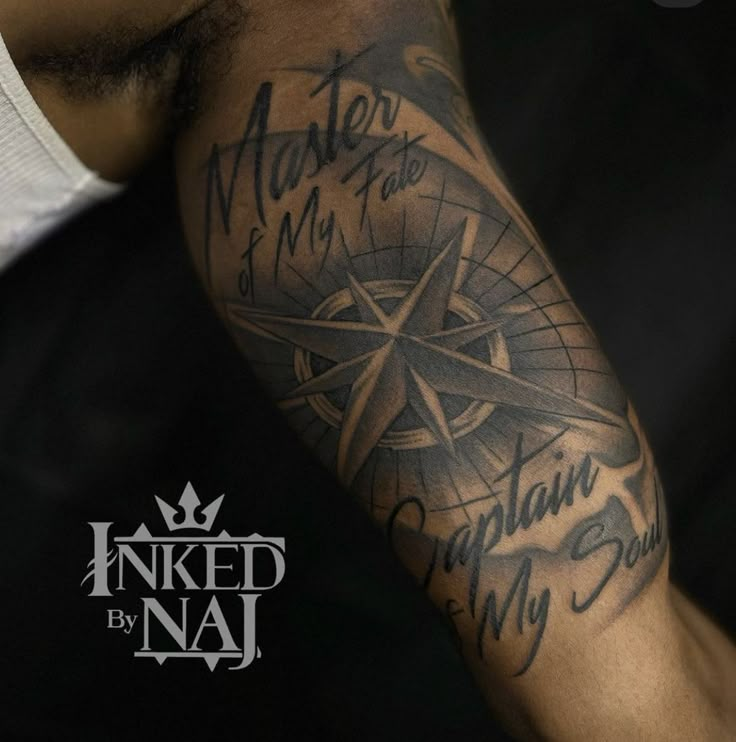 a man's arm with some writing on it and a compass in the middle