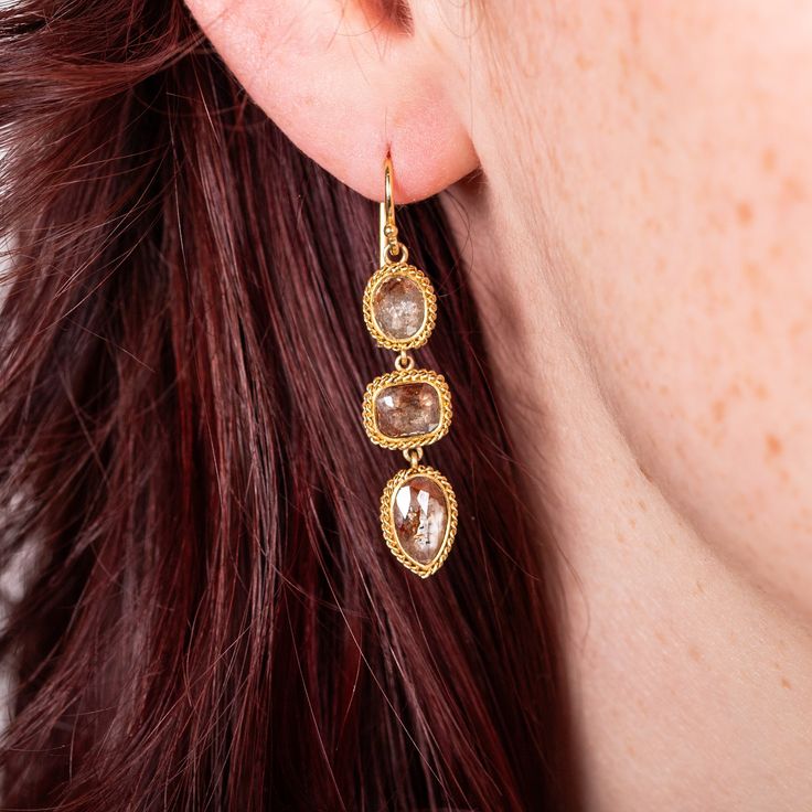 These spectacular earrings feature a trio of carefully curated Champagne Diamonds in warm bronze hues. The show-stopping stones are set in 18K yellow gold bezels adorned with hand-braided gold chain. Technical Details Metal: 18k yellow goldDiamond: 4.91 cts.Total Length: 40mmEarwire: 18k french hookHandmade in New YorkStyle # E-2260-DIA Luxury Gold-plated Multi-stone Earrings, Luxury Multi-stone Gold Plated Earrings, Velvet Sky, Champagne Diamond, Gold Chain, Gold Chains, Champagne, Diamonds, Yellow Gold