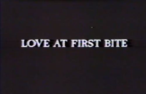 the words love at first bite written in white on a black background