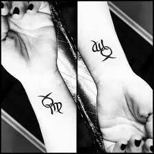 two wrist tattoos with the word taurus and virgo together