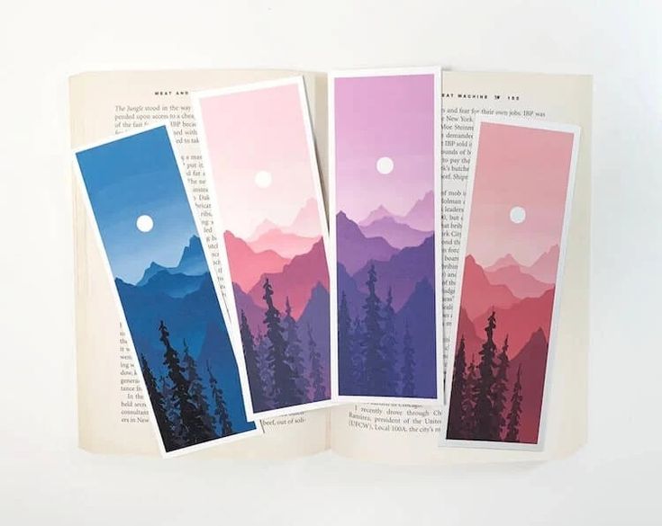 three bookmarks with mountains in the background and trees on each side, one has a full moon