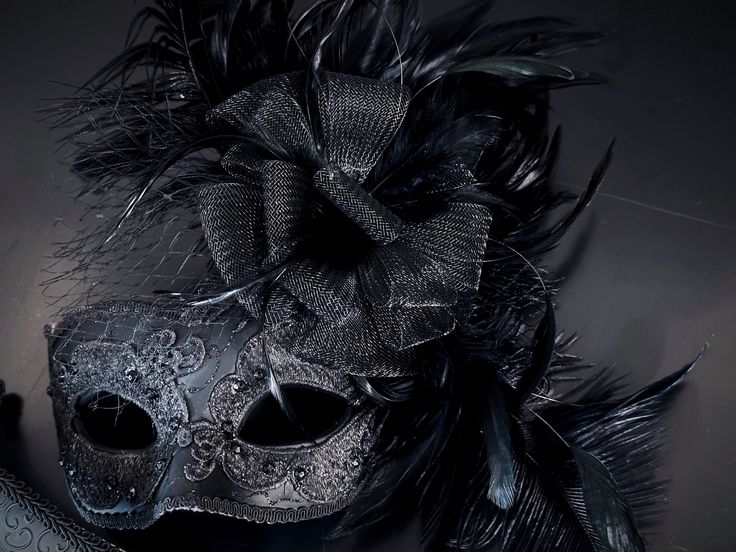 This captivating set includes two stunning masks, both designed in the classic Venetian style. The women's mask is adorned with fishnet, lace fabric, and feathers while the men's mask has shimmer. From masquerade balls to themed celebrations, our couples mask set is the perfect choice for any look!


Age Group/Gender - Adult/Unisex

Size/Type - One size fits all adults

Mask Color - Black
Women Mask - Black with lace overlay and black feathers and tulle flower
Men Mask - Black with filigree glit Elegant Halloween Masquerade Masks And Prosthetics, Elegant Mask For Carnival, Carnival Evening Masquerade Eye Mask, Elegant Carnival Mask Costume Accessory, Elegant Masks For Carnival And Halloween, Elegant Party Eye Mask, Gothic Masquerade Mask For Carnival Evening, Elegant Masks For Costume Party And Carnival, Elegant Carnival Masks For Costume Party