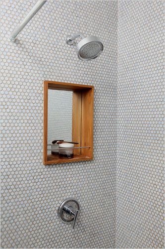 a bathroom with a shower head, mirror and hand held faucet in it