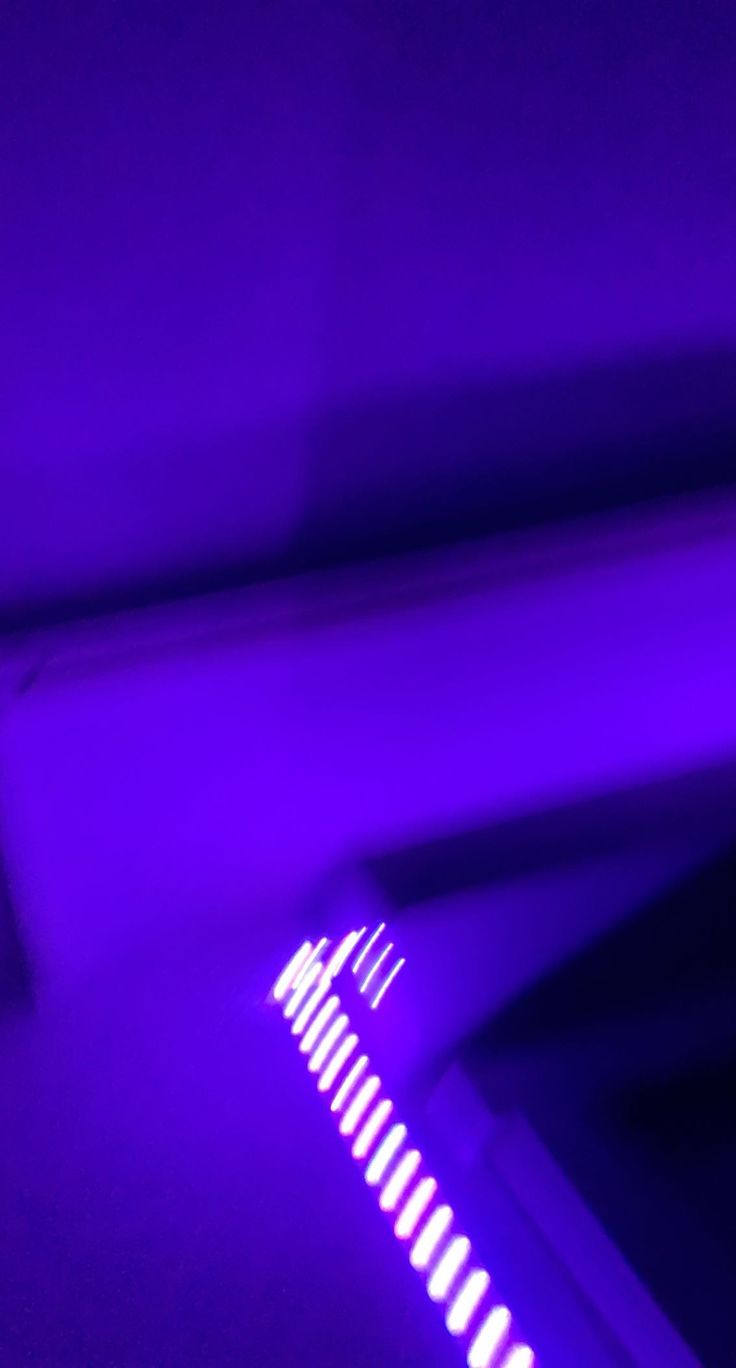 a close up of a toothbrush with purple light