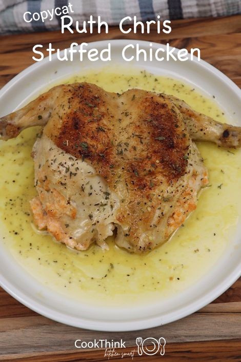 the chicken is covered in gravy and served on a white plate with yellow sauce