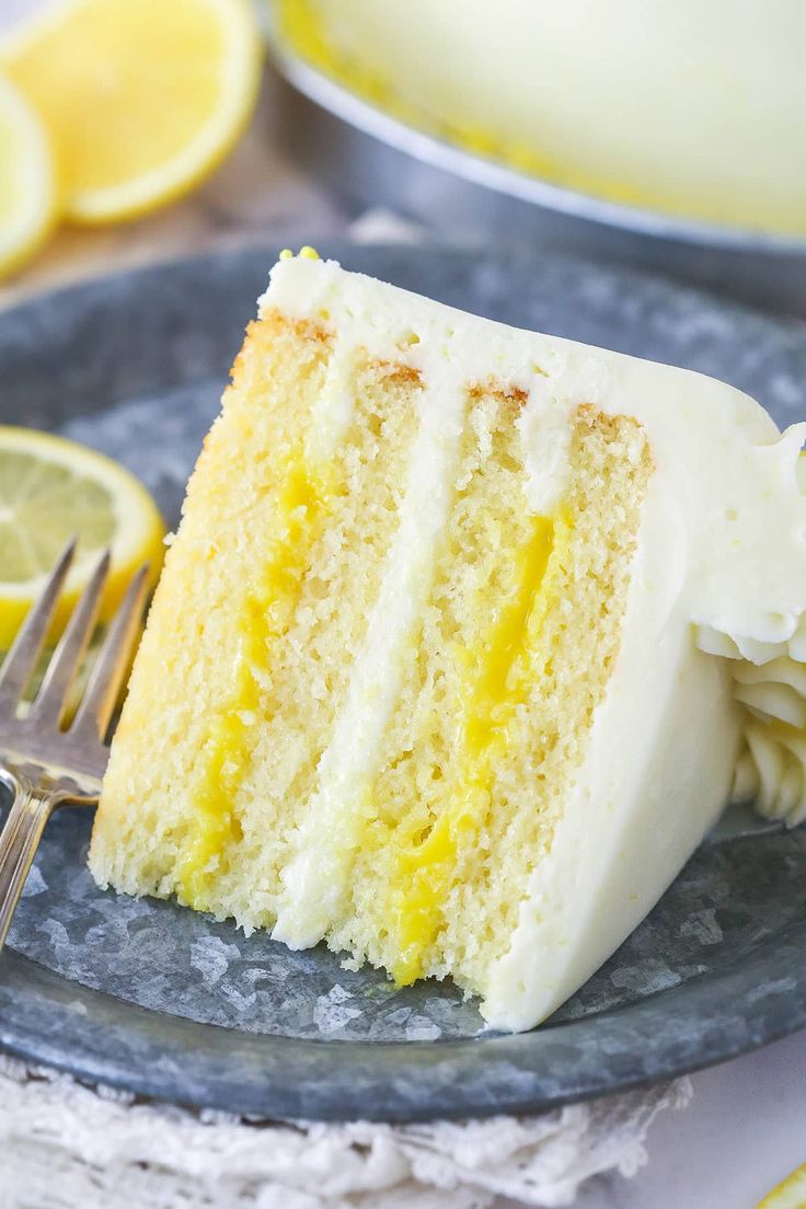 a slice of lemon cake on a plate with a fork