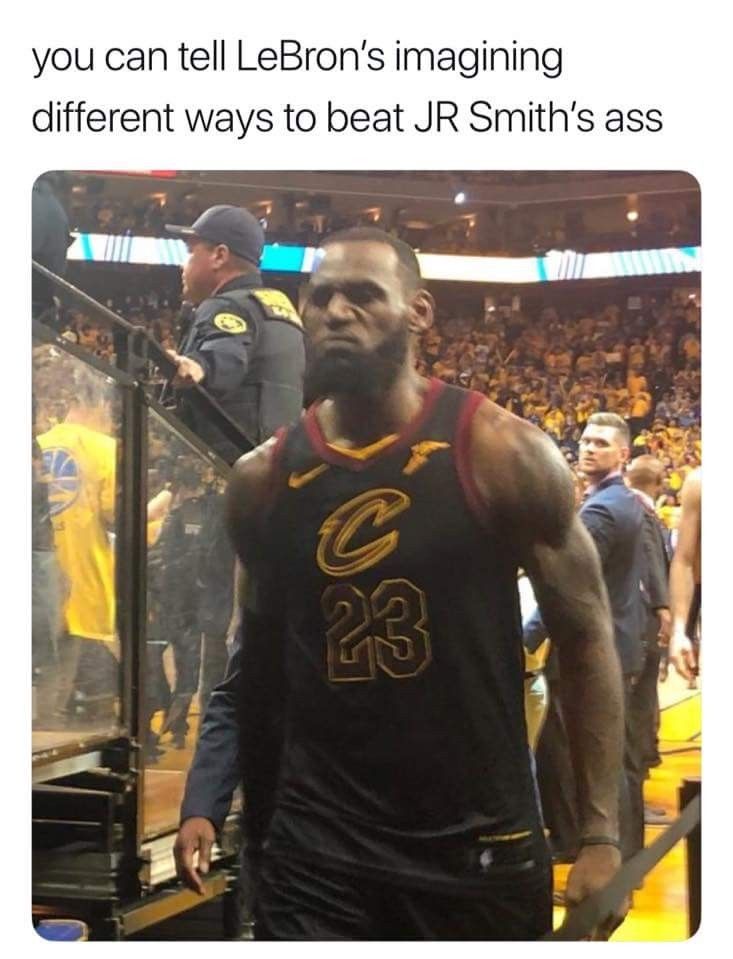 the basketball player is walking down the court with his team's uniform on and people in the stands behind him