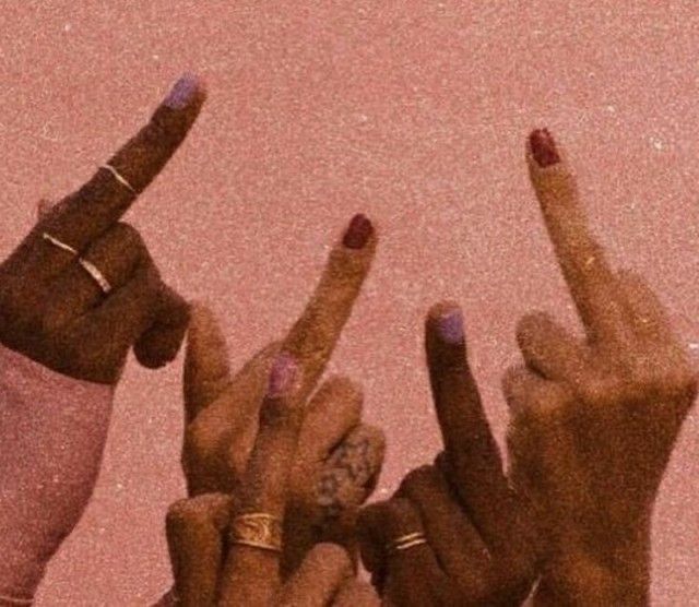 four fingers pointing up in the air with their fingers pointed at something on top of them