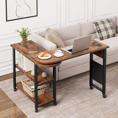 a living room with a couch, coffee table and laptop