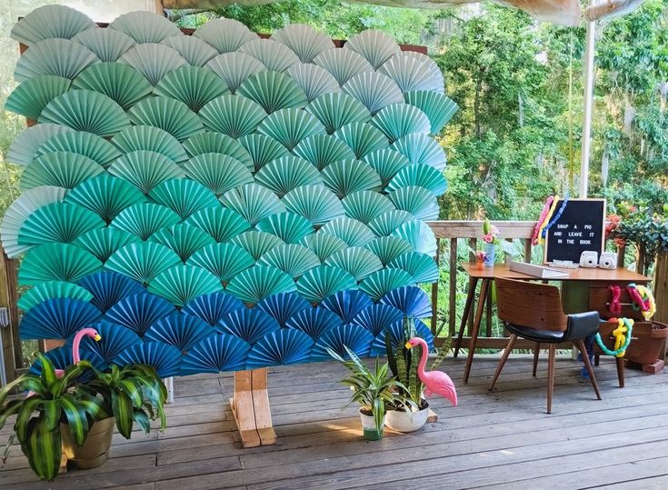 an outdoor area with tables, chairs and umbrellas on the deck outside in front of trees