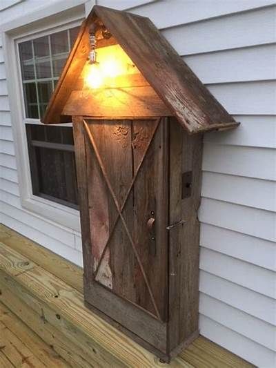 a light that is on the side of a house next to a door and window