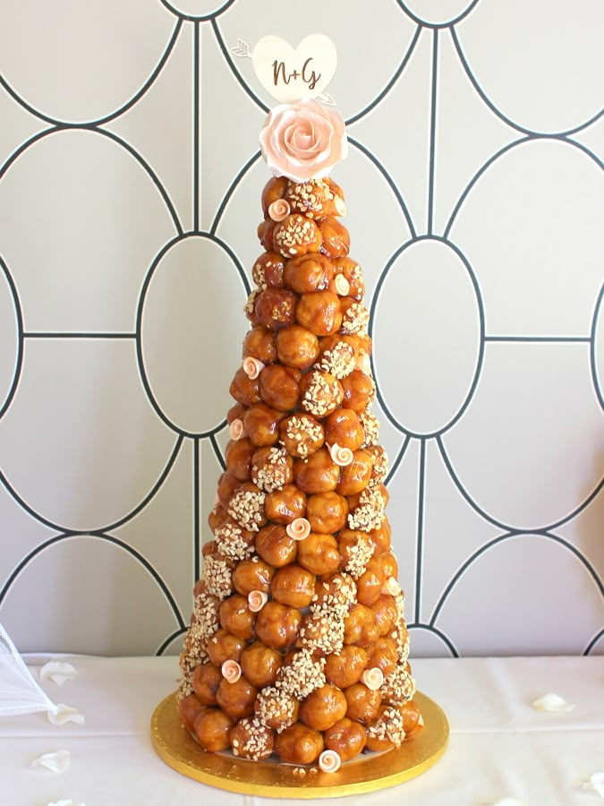 a cake made to look like a christmas tree with nuts on top and a flower in the middle