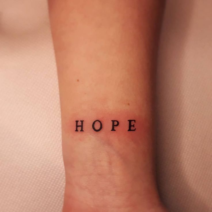 a person with a small tattoo that says hope