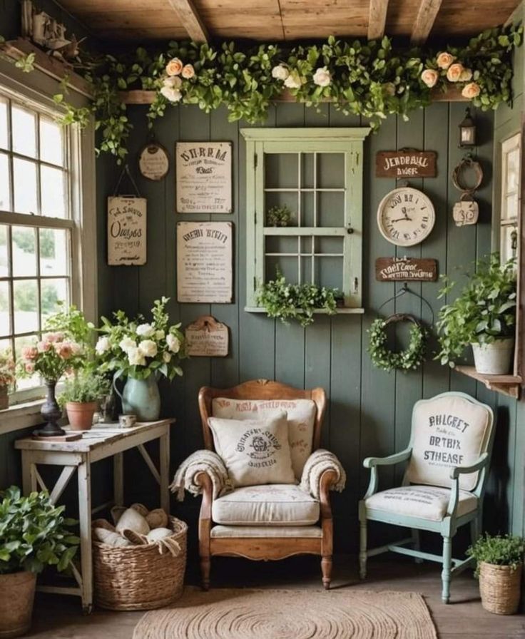 a room with green walls and lots of plants on the windows sill, chairs and tables