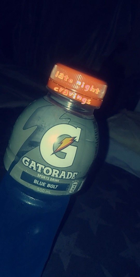 a bottle of gatorade sitting on top of a table