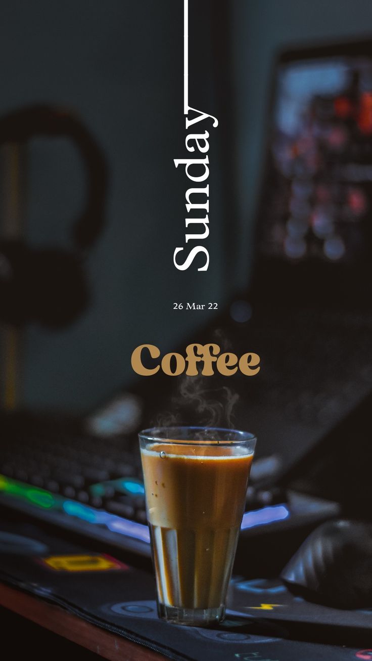 a cup of coffee sitting on top of a computer desk