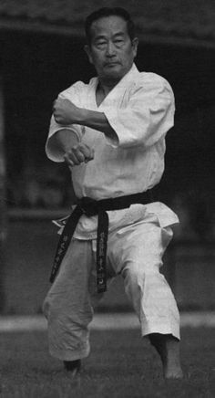 an old photo of a man practicing karate