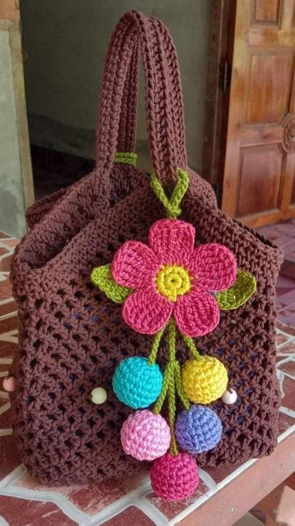 a crocheted bag with flowers on it