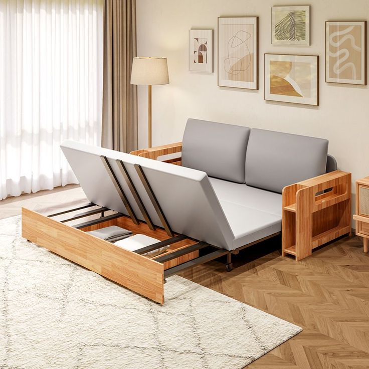 a couch that is sitting on top of a bed frame in a room with wood flooring