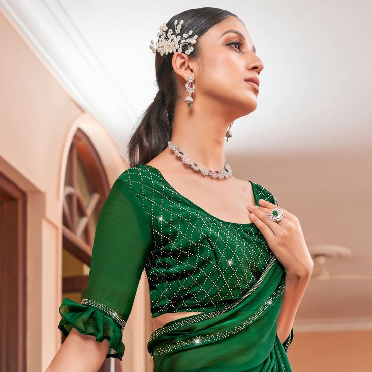 Green colored saree is made from georgette fabric which is highlighted with beautiful woven with swarovski work as shown. Comes along with unstitched silk georgette blouse piece which you can customise as per your design/style. Occasion - You can wear this saree for party and functions. Note:- the actual product may differ slightly in color and design from the one illustrated in the images when compared with computer or mobile screen. Measurements: Saree : Georgette : 5.5 Mtrs Blouse : Georgette Elegant Pre-draped Chiffon Saree, Elegant Georgette Sharara With Unstitched Blouse, Elegant Organza Blouse For Navratri, Eid Georgette Blouse With Mirror Work, Elegant Festive Georgette Blouse Piece, Semi-stitched Georgette Blouse For Wedding, Elegant Unstitched Green Choli, Semi-stitched Chinon Party Wear Blouse, Elegant Pre-draped Chiffon Saree With Unstitched Blouse