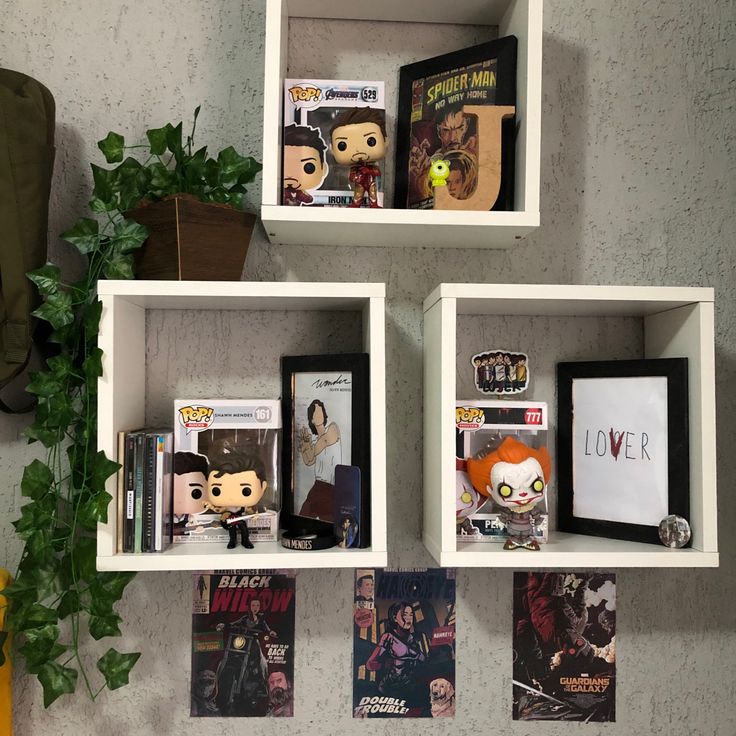 three white shelves with pictures and movies on them