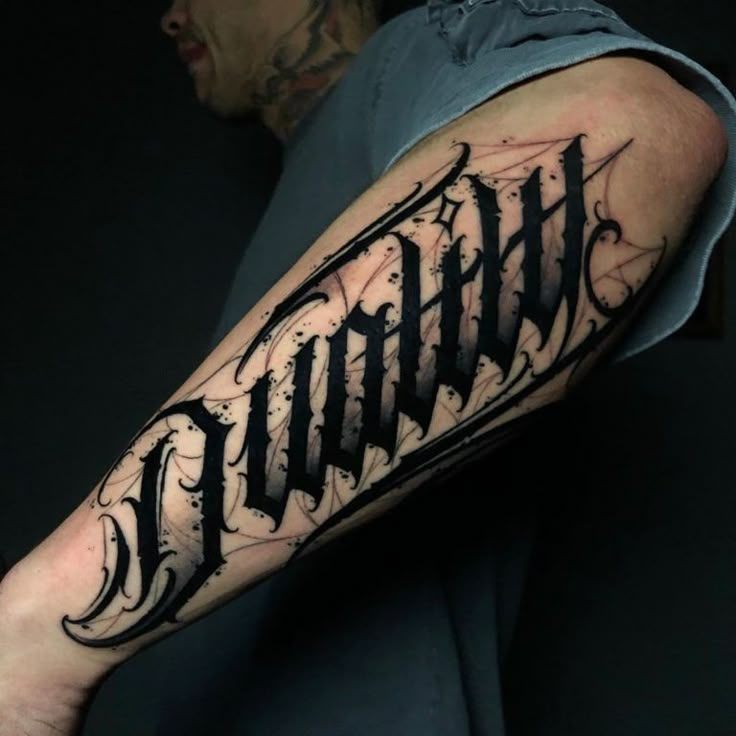 a man's arm with the word tattoo on it