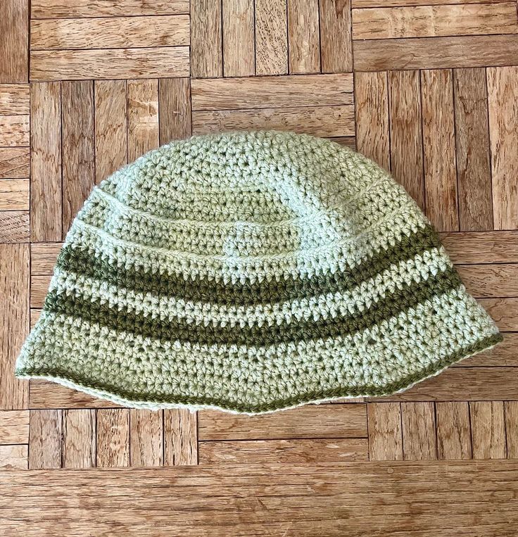 a crocheted hat laying on top of a wooden floor