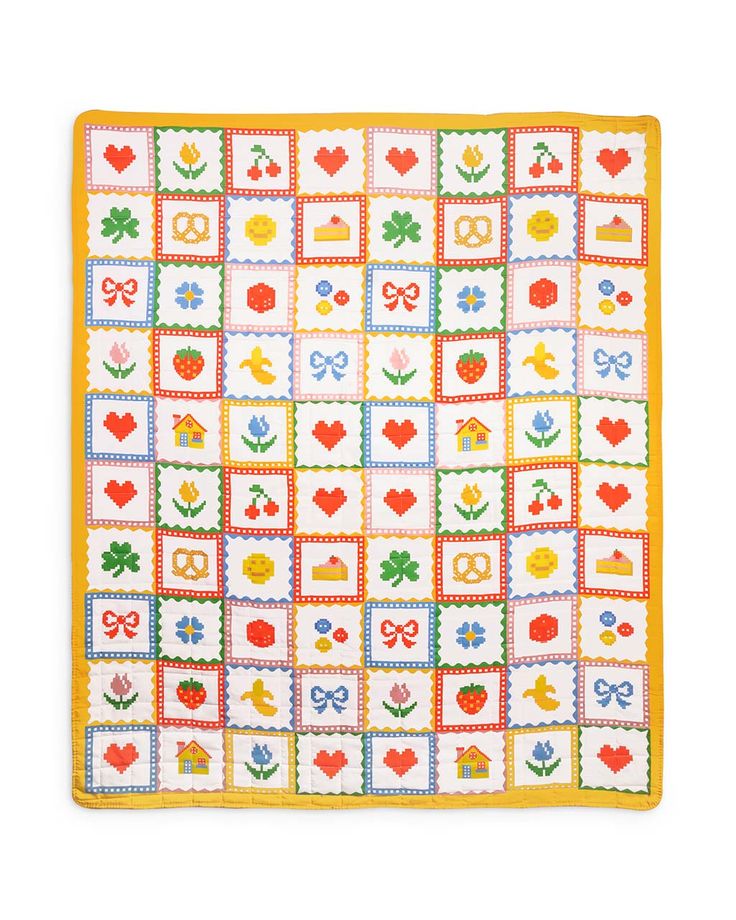 a square quilt with hearts, flowers and other things on the squares is shown in yellow