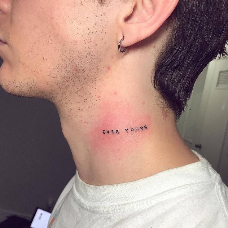 a man with a small tattoo on his neck that says, ever you're