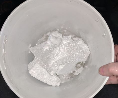 a person holding a bowl filled with white powder