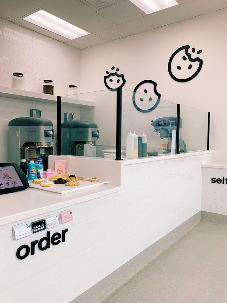 an order counter in a store with black and white wall decals