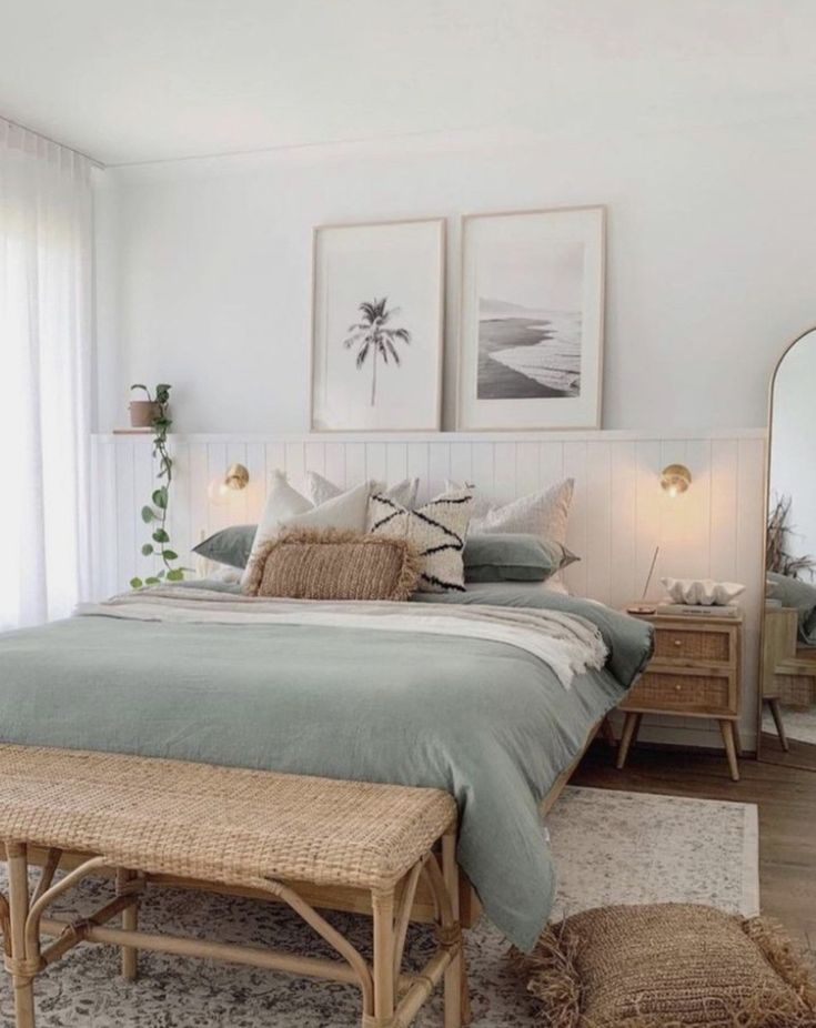 a bedroom with a bed, dresser and two framed pictures on the wall above it