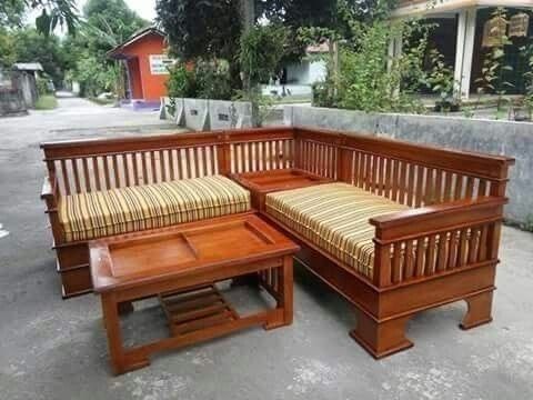 a wooden bench and table sitting next to each other on the sidewalk in front of a house