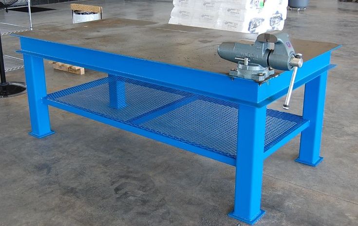 a blue work bench with a machine on top