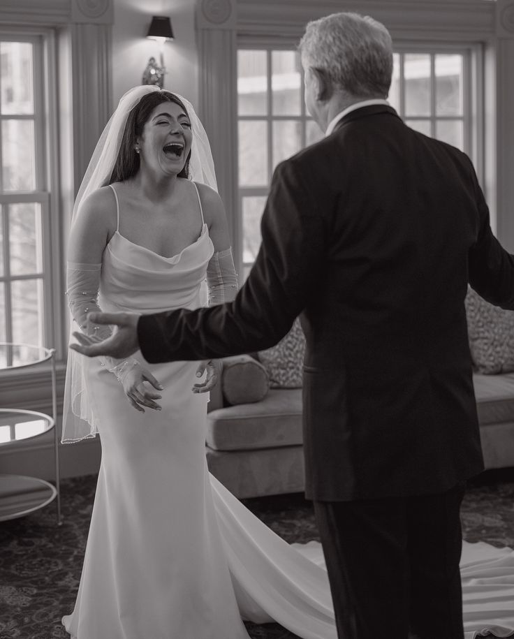 a bride and groom are laughing together in the living room