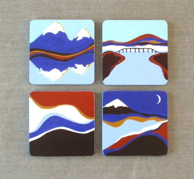 four coasters with different designs on them