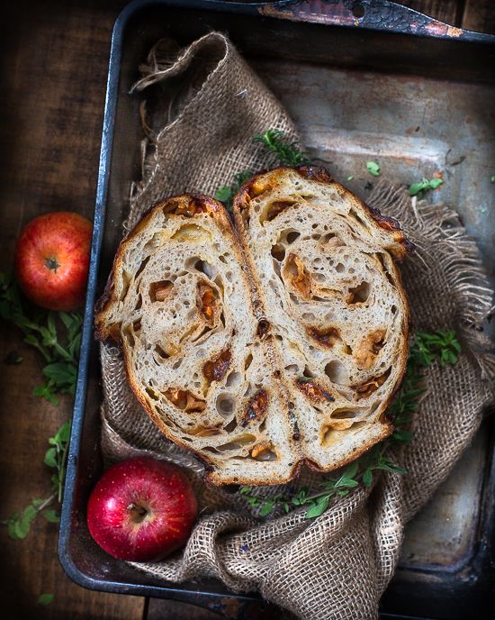 two pieces of bread sitting on top of a pan next to an apple and another piece of fruit