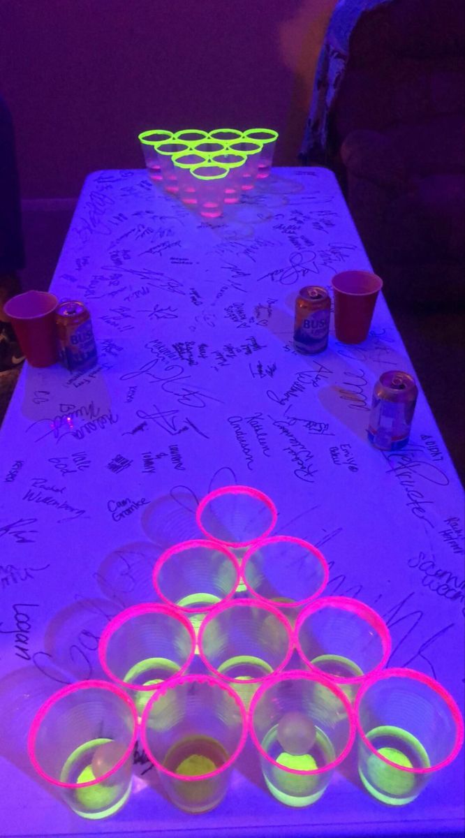 a table with cups and neon lights on it