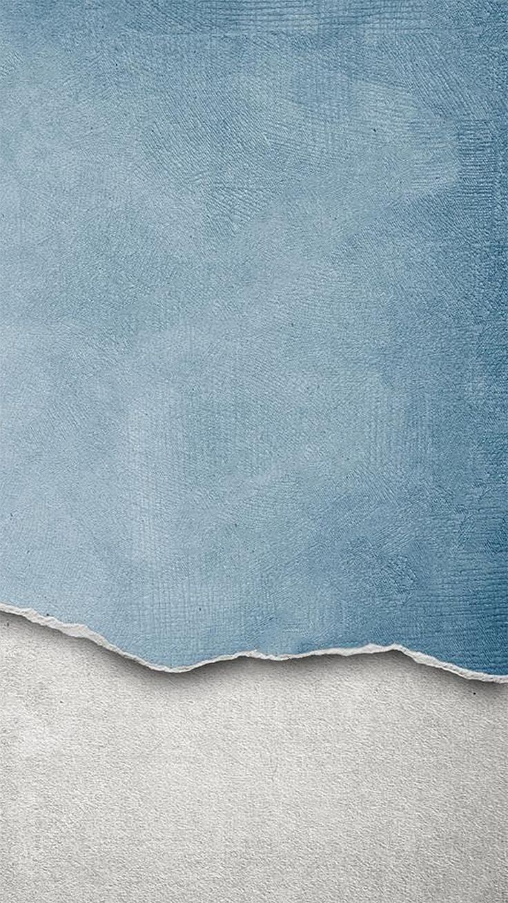 an image of a blue and white background with torn off paper on the bottom half