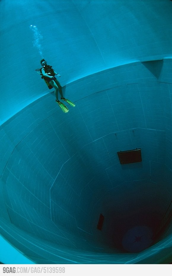 a person is swimming in the blue water