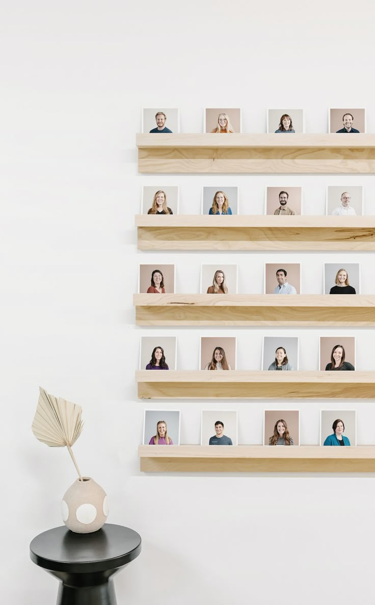 a wall mounted shelf with multiple photos on it