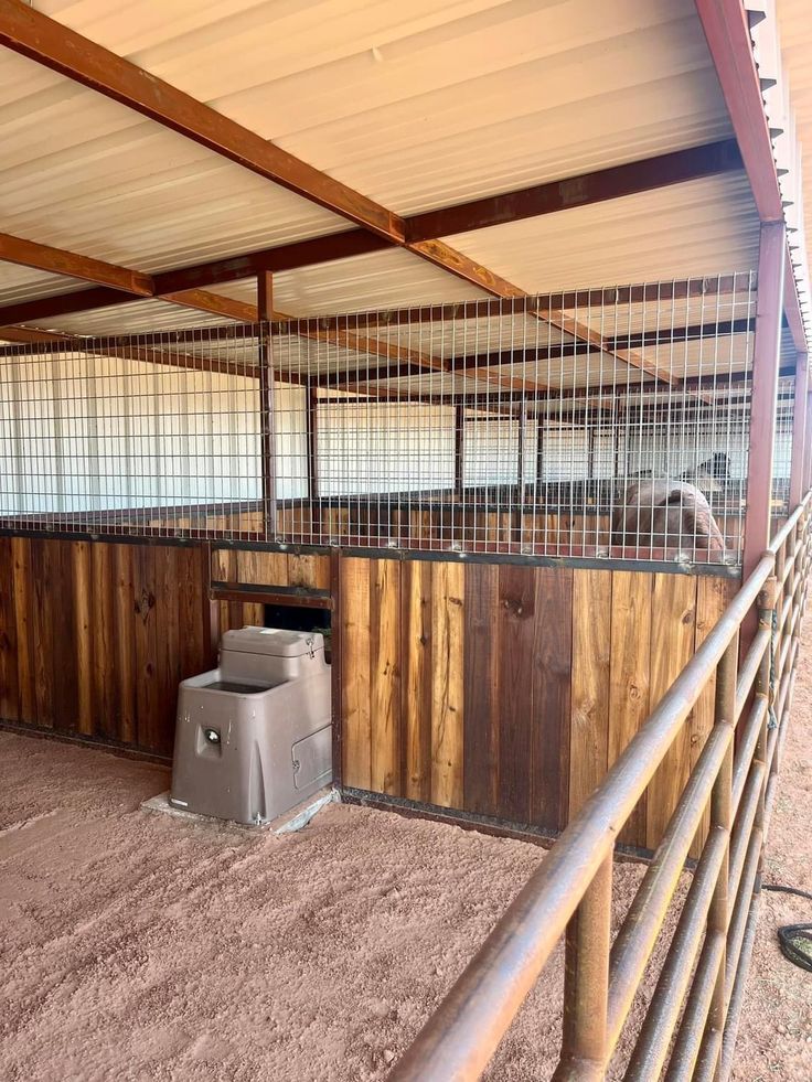 the inside of a barn with some animals in it