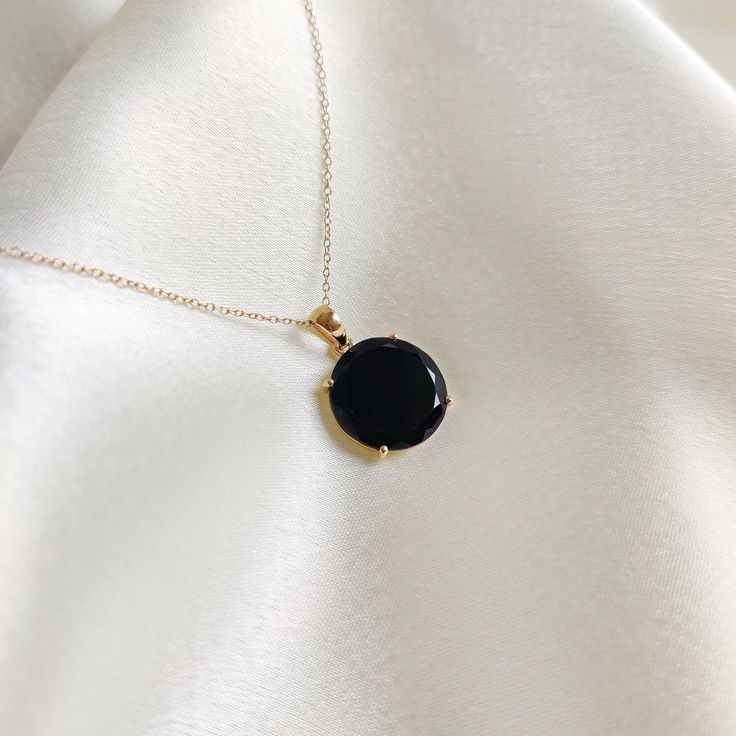 This stunning pendant is set in 14k Solid Yellow Gold with Natural Black Onyx with utmost precision. It is a unique gemstone pendant for nearly every occasion and is completely hassle-free jewelry. ITEM DETAILS: * GEM: Black Onyx * GEM Size: 15x15mm * GEM Shape: Round (Flat Cut) * Gem Weight: 6.05 carats * Gold Purity: 14KT  * Gold Weight: 0.90 gram * Total Weight of the Pendant: 2.11 gram The Gold purity is guaranteed and it comes with an authentic 14KT gold hallmark. Since my items are handmad Onyx Gemstone Aesthetic, Black Spinel Gemstone Necklace, Elegant Round Pendant Necklace With Black Enamel, Luxury Black Oval Necklaces, Luxury Round Onyx Jewelry, Luxury Onyx Jewelry, Timeless Onyx Gemstone Jewelry, Timeless Black Gemstone Jewelry, Black Onyx Jewelry For Formal Occasions