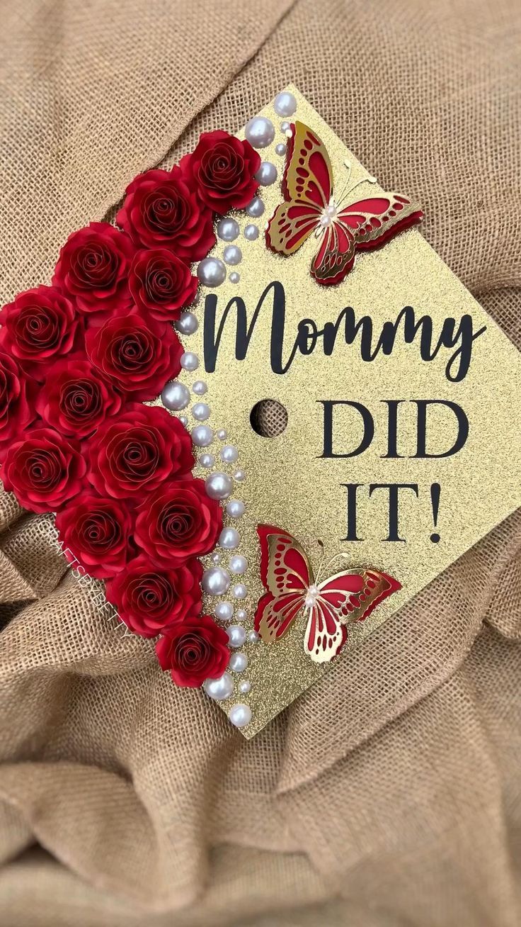 a graduation cap with roses and butterflies on it that says mommy, did it?